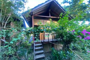 a tree house with stairs leading up to it at SPOT ON 93511 Rinjana Homestay in Tanjung