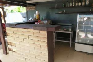 a kitchen with a brick counter and a refrigerator at SPOT ON 93511 Rinjana Homestay in Tanjung