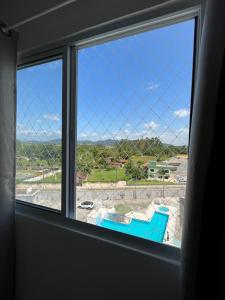 a window with a view of a pool at Apartamento para locação em Itajai SC in Itajaí