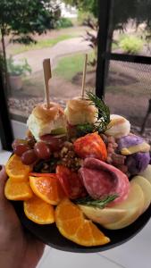 a plate of food with fruit and vegetables on it at A Villas Resort & Restaurant in Zamboanguita