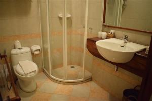 a bathroom with a shower and a toilet and a sink at Sala Prabang Hotel in Luang Prabang