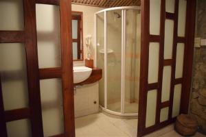 a bathroom with a shower and a sink at Sala Prabang Hotel in Luang Prabang
