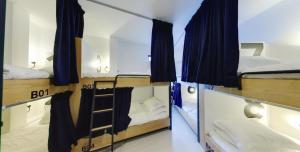 a group of three bunk beds in a room at Modern Cave Boutique Stay in Melaka