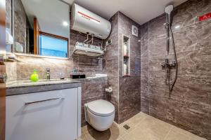 a bathroom with a toilet and a sink and a shower at Plaza Residence Apartment - Shenzhen Futian Convention & Exhibition Center in Shenzhen