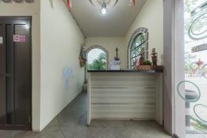 a hallway with a counter in a room at Urbanview Hotel Cianjur City Park by RedDoorz in Tjiandjur