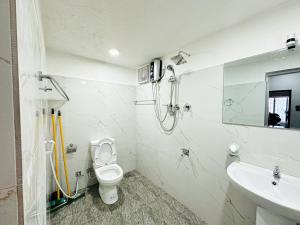 a bathroom with a toilet and a sink at Villa Beach Heaven in Hikkaduwa