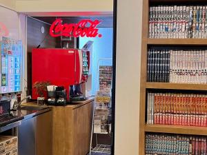 a coffee shop with a red sign on the wall at HOTEL StoRK Naha Shintoshin - Vacation STAY 27627v in Naha +38 photos