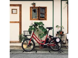 a red bike parked in front of a house at HOTEL StoRK Naha Shintoshin - Vacation STAY 27627v in Naha