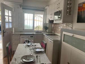 a kitchen with a table with wine glasses on it at ESTUDIO EN SANJOSE A 50 M DE LA PLAYA in San José