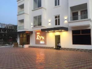 a large white building with a sign on it at Hotel SRI KPN , Austinabad in Austinābād