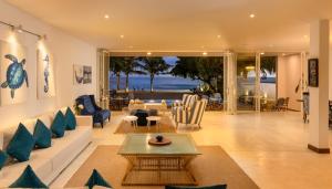 a living room with a couch and a table at Vis Ta Vie -Thema Collection in Mirissa