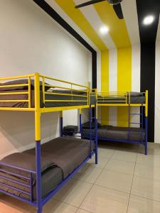 two bunk beds in a room with yellow and white walls at Manhattan Austin 2-6 pax Family Cozy Suite in Johor Bahru