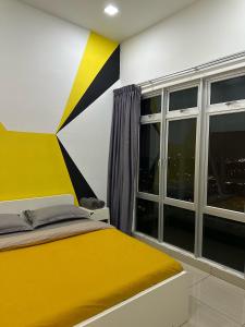 a bedroom with a yellow bed and a window at Manhattan Austin 2-6 pax Family Cozy Suite in Johor Bahru