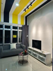 a living room with a couch and a tv at Manhattan Austin 2-6 pax Family Cozy Suite in Johor Bahru