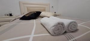a bed with towels and pillows on it at RutSuite in El ‘Affūle +22 photos