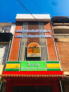 a building with a sign on the side of it at Annie Backpacker Hostel in Ban Nongdouang
