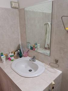 a bathroom with a sink and a mirror at Annie Backpacker Hostel in Ban Nongdouang
