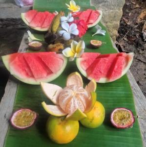a bunch of fruit on a green leaf at JungleRiverHouse in Bukit Lawang