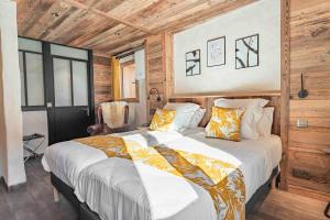 a bedroom with a large bed with wooden walls at CHALET CHARMING BED and BREAKFAST in Les Gets