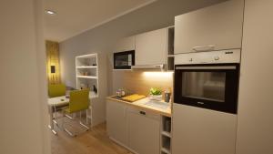 a kitchen with a counter and a dining room at Adapt Apartments Wetzlar in Wetzlar