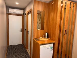 a room with a hallway with a door and a room with a refrigerator at istanbul vipinnhotels in Istanbul