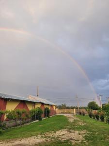 a rainbow over a house with a yard at MYONNA Style Slobozia 