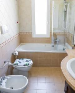 ein Badezimmer mit einem WC, einer Badewanne und einem Waschbecken in der Unterkunft tra verde e mare in Imperia