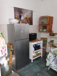 a kitchen with a stainless steel refrigerator and a sink at Padullella, mare e sole!! in Portoferraio