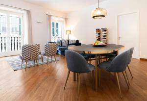 a living room with a dining room table and chairs at The Seven Residence in Genova