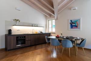 a kitchen and dining room with a table and chairs at The Seven Residence in Genoa
