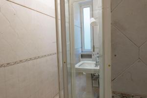 uma casa de banho com um lavatório e um espelho em La Casa di Sissi em La Spezia