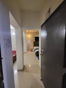 a hallway with a door and a room with a bed at THE PERFECT STAYS: SUPREME BLISS VILLA in Lonavala