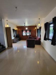 a large living room with a couch and a table at THE PERFECT STAYS: SUPREME BLISS VILLA in Lonavala