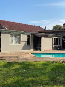 a house with a swimming pool in the yard at M D J Hayfields Guest House in Pietermaritzburg
