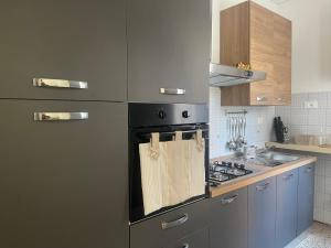 a kitchen with a stainless steel refrigerator with a towel on it at Casa vacanze nonna Prassede Alloggio incantevole in casa indipendente .. in Lecco