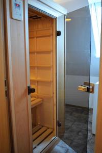 a closet with a glass door in a bathroom at Rote Koje in Dagebüll