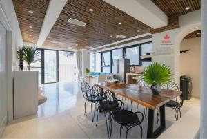 a dining room with a table and chairs at Maple Hotel & Apartment in Nha Trang