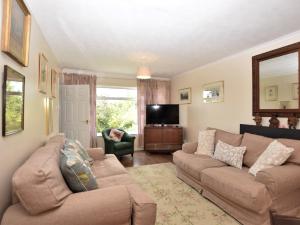 a living room with two couches and a television at 3 Bed in Great Snoring KT075 in Great Snoring