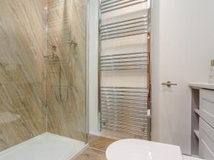 a bathroom with a toilet and a glass shower at 2 Bed in Bude 66127 in North Tamerton