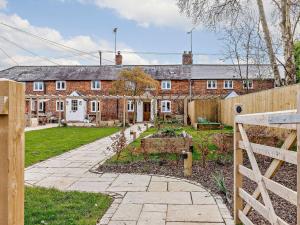 a brick house with a garden in front of it at 1 Bed in Marlborough 65123 in Fyfield