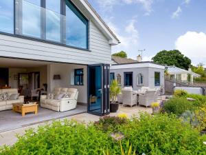 a patio with white furniture and a house at 3 Bed in Bovey Tracey 64380 in Bovey Tracey