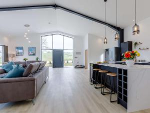 an open living room with a couch and a kitchen at 4 Bed in Berrynarbor 65786 in Berrynarbor