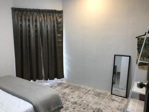 a bedroom with a bed and a mirror and a window at The P Lakehouse in Tanjong Sepat