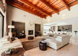 un soggiorno con divani bianchi e TV di umVangati House a Hoedspruit Altre 37 foto