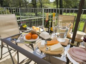 a glass table with cheese and fruit on a balcony at 3 Bed in Bedale G0095 in Crakehall