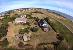 una vista aérea de una casa en una colina junto al océano en Süderhaus Hiddensee App 8 en Neuendorf
