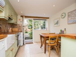 a kitchen with a wooden table and chairs at 2 Bed in Chideock DC194 in Chideock