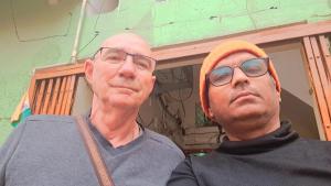 dos hombres parados uno al lado del otro con gafas en Narmada Guest House, en Indore