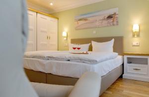 um quarto de hotel com uma cama com dois copos de vinho em Villa Waldschloss App 2 em Bansin