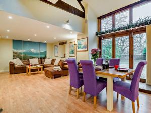 a living room with a table and purple chairs at 2 Bed in Coleford 78181 in Symonds Yat